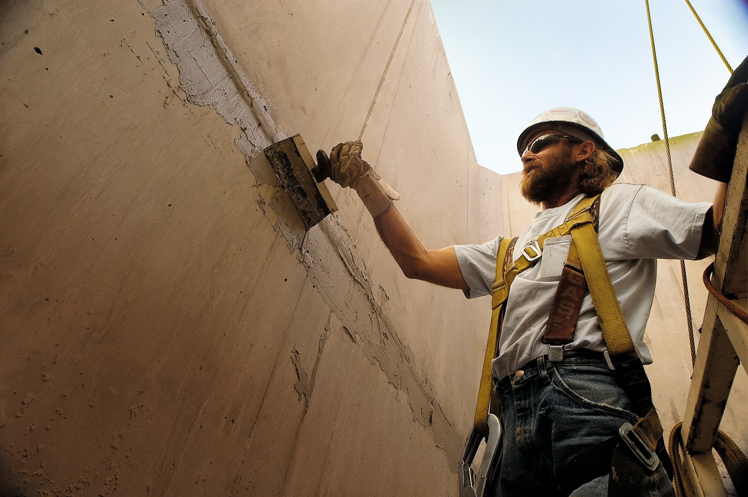 Man applying concrete repair mortar at Hoover Dam bypass bridge project