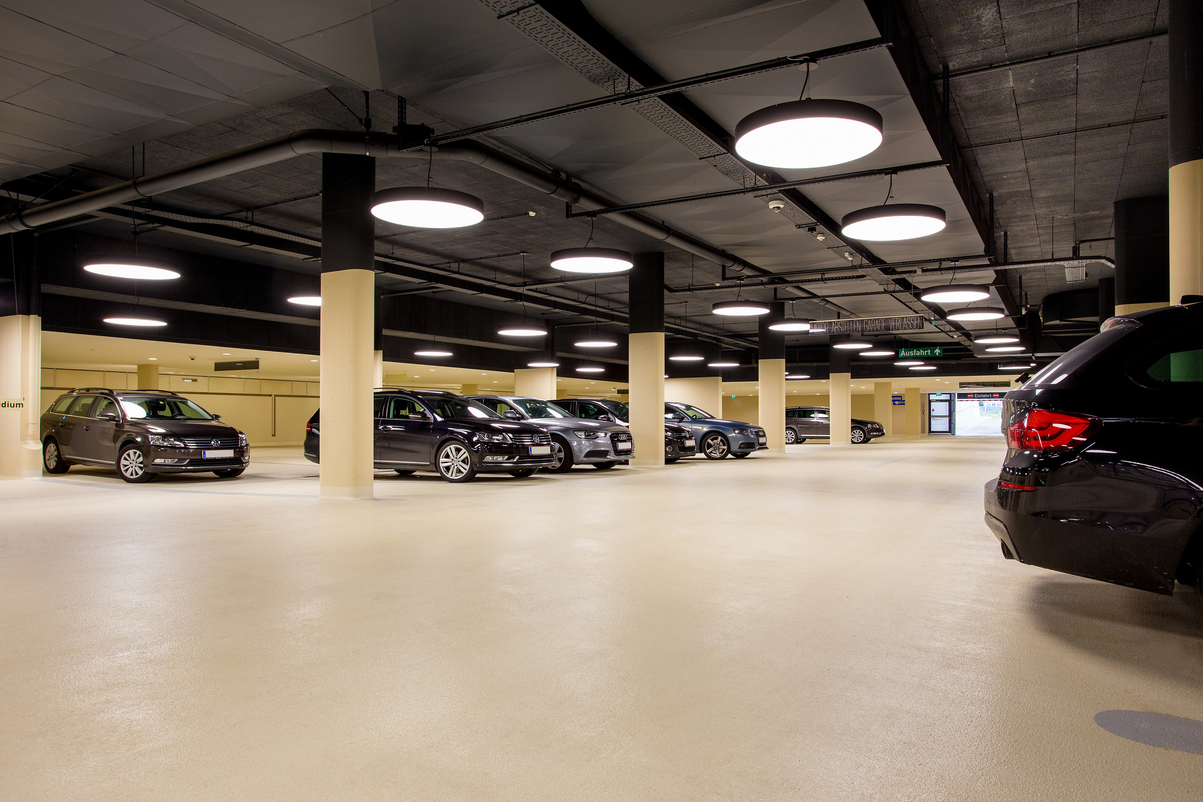 Cars in indoor parking garage made with Sikafloor coating system